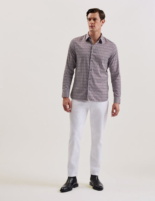 A male model wearing a dark red geometric patterned slim fit shirt with long sleeves and a classic collar.