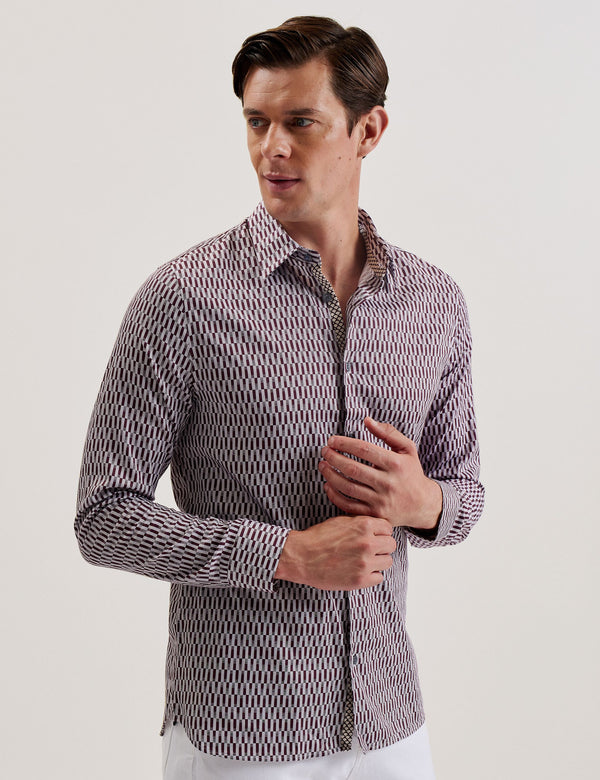 A male model wearing a dark red geometric patterned slim fit shirt with long sleeves and a classic collar.